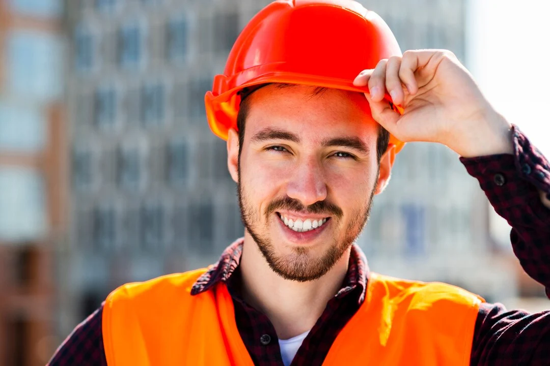 close-up-portrait-smiling-construction-engineer_23-2148233726